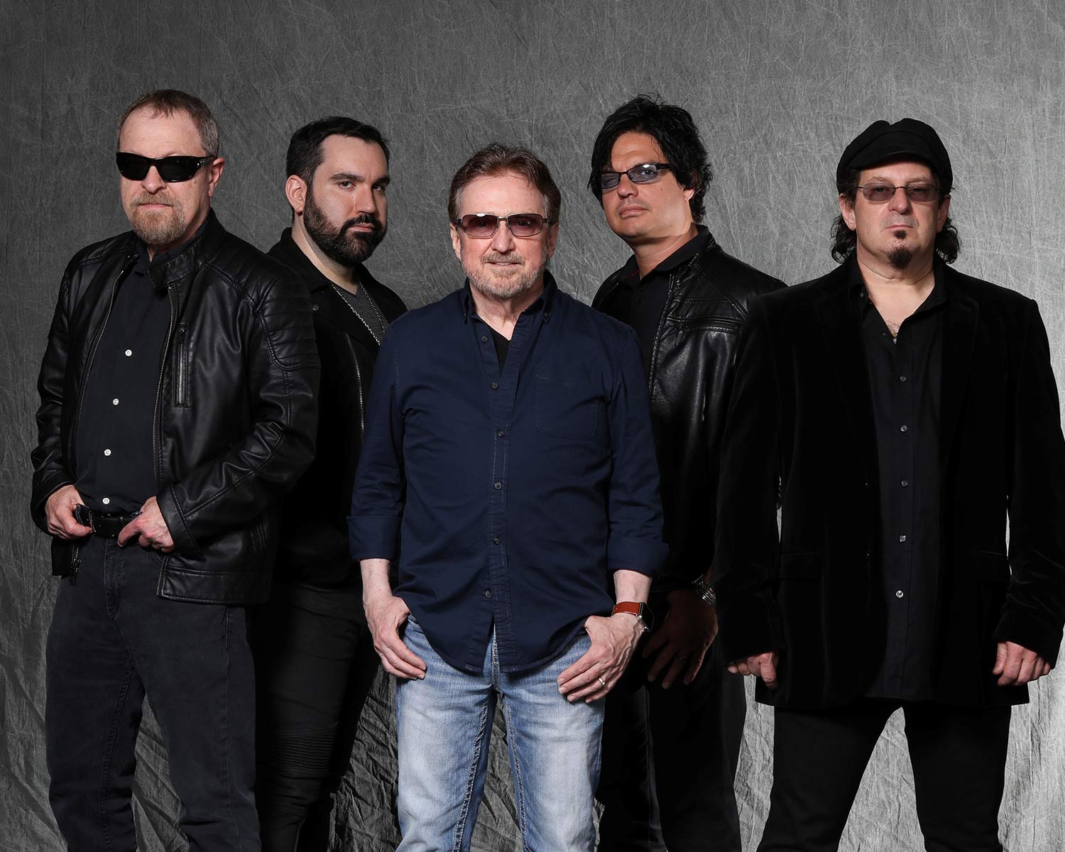 The members of Blue Öyester Cult pose together against a light gray background.