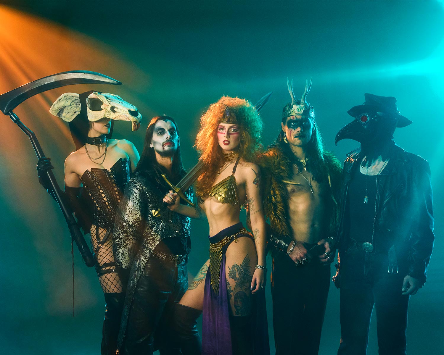 The members of Castle Rat pose in imaginative stage costumes under colorful lighting.