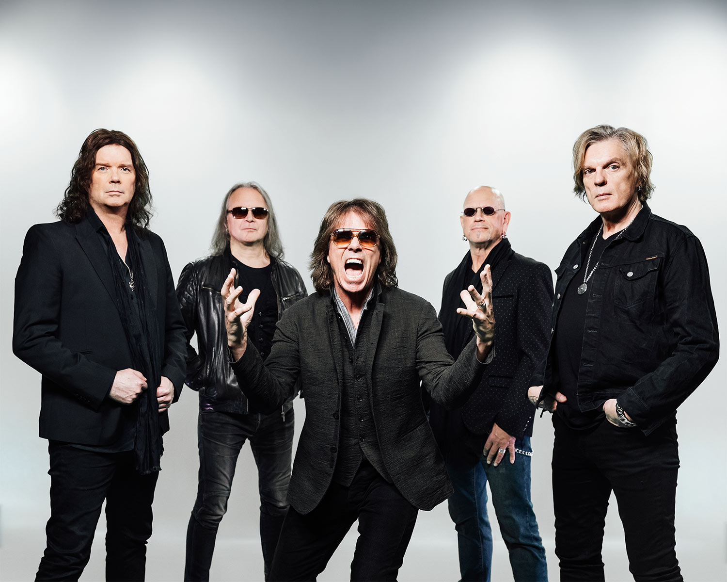 The members of Europe are posing together against a bright background.