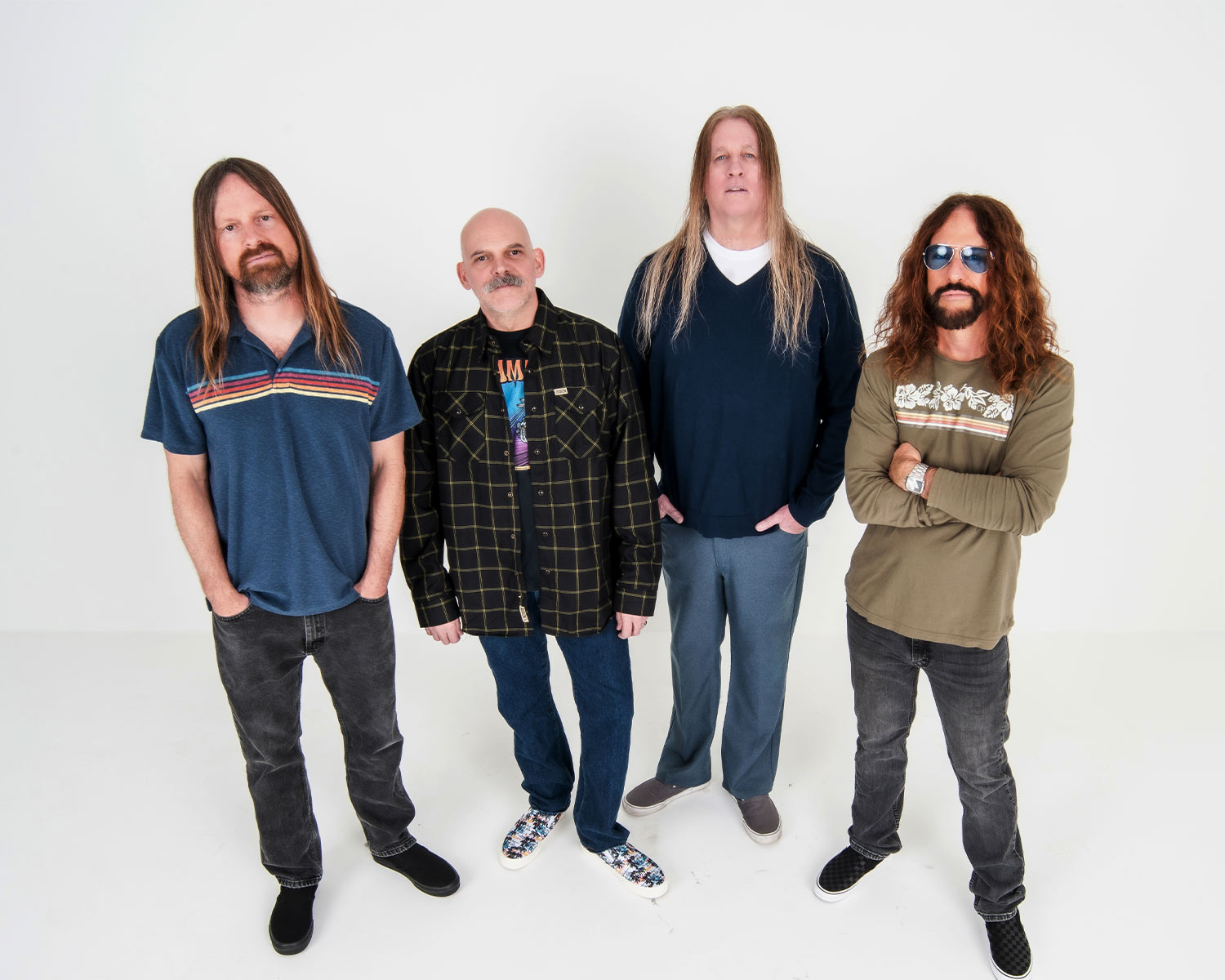 The members of the band Fu Manchu are posing together against a white background.