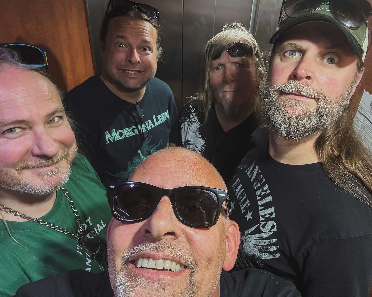 The members of Morgana Lefay are posing together in an elevator.
