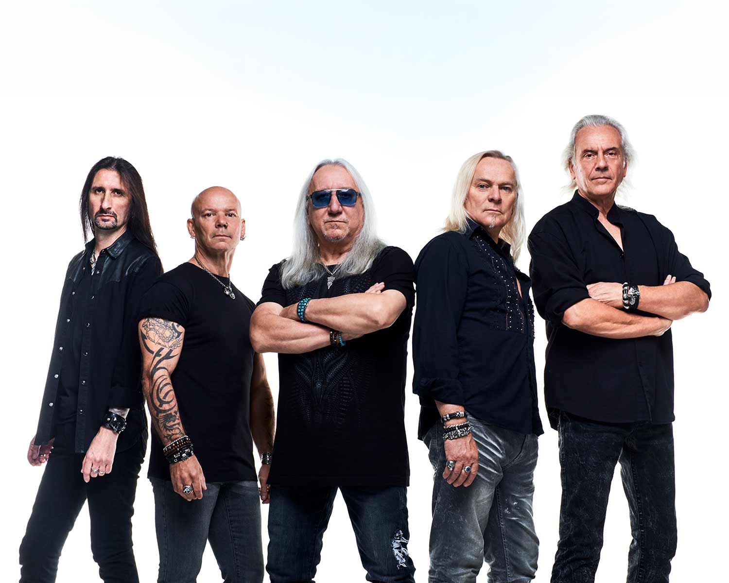 The members of Uriah Heep pose against a white background.